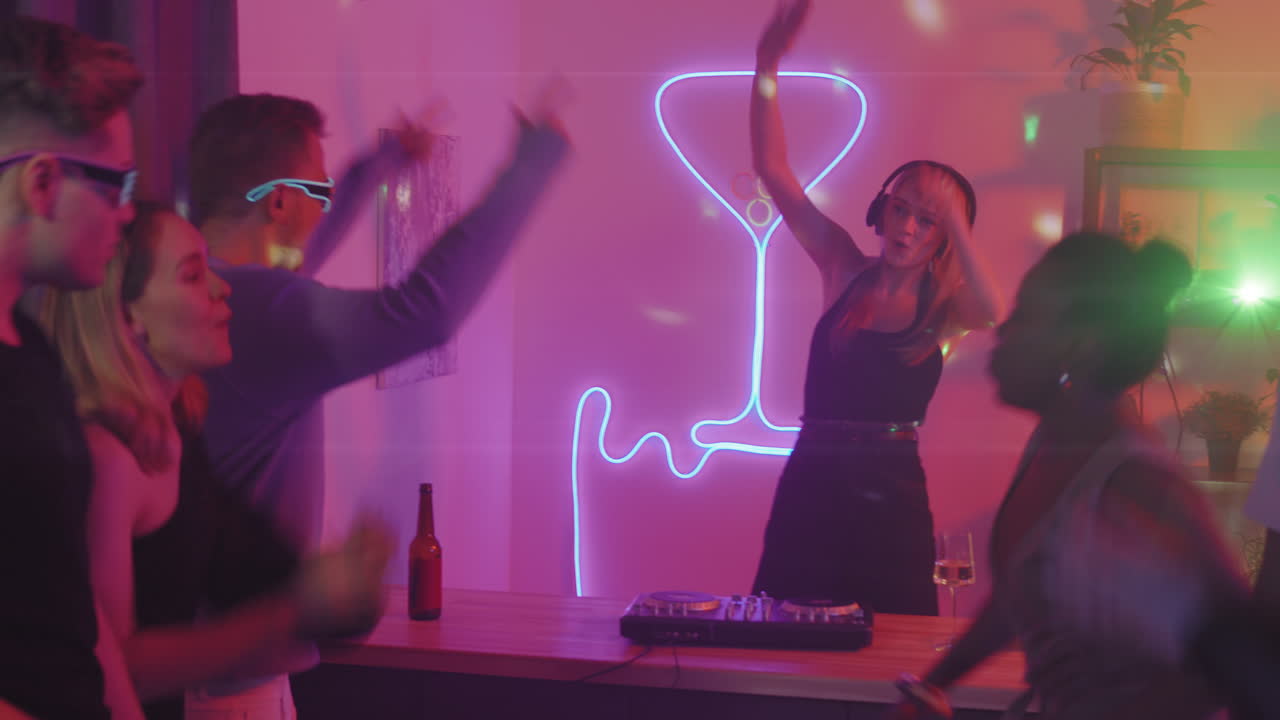 Young People Dancing to Music at House Party