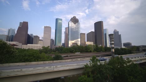 Establishing-shot-of-downtown-Houston-as-cars-pass-by-on-I-45-frreeway