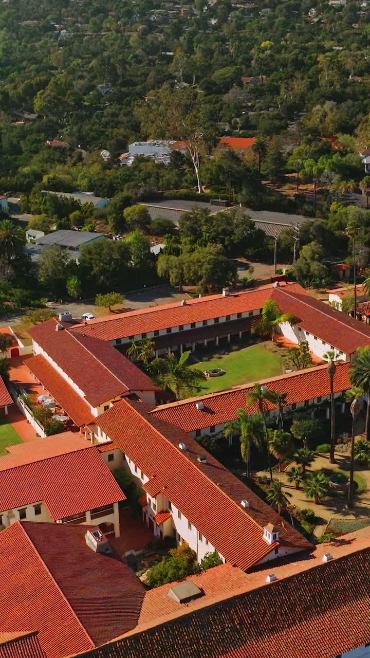 Rich luxurious mansions with beautiful buildings and nature around. Sunny picture of amazing Santa Barbara from aerial view. Vertical video