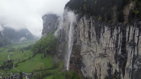 Staubbach-Waterfall-Falls-on-Lauterbrunnen-Mountain-Cliff,-Aerial-Landscape
