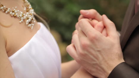 couple holding hands at wedding