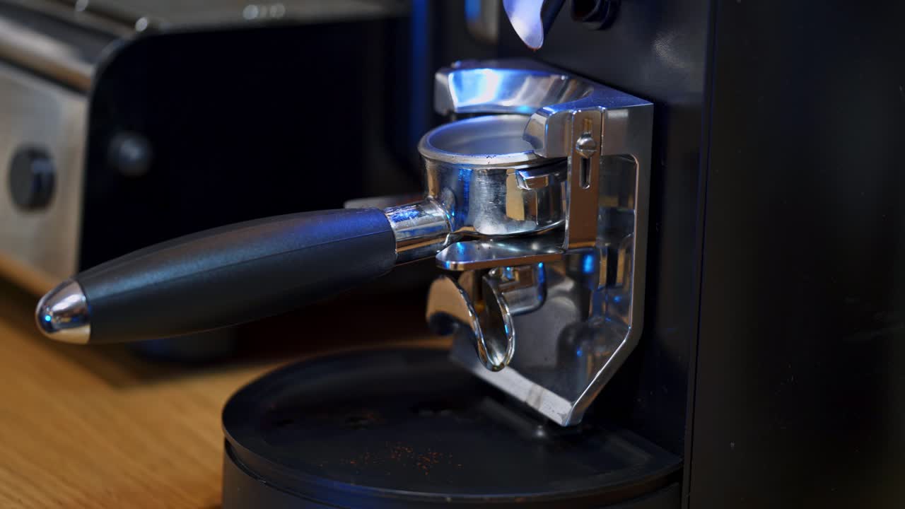 Coffee machine. Making coffee in a coffee machine. Woman prepares coffee in the kitchen. Female's hand makes coffee step by step. Close-up.