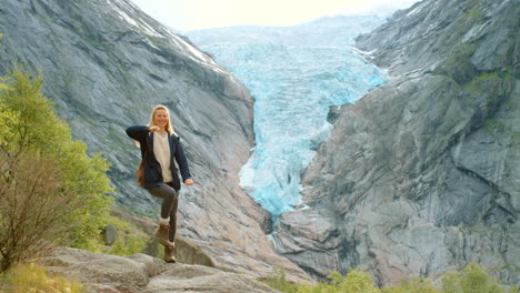 happy woman hiking in norway's glacier mountains