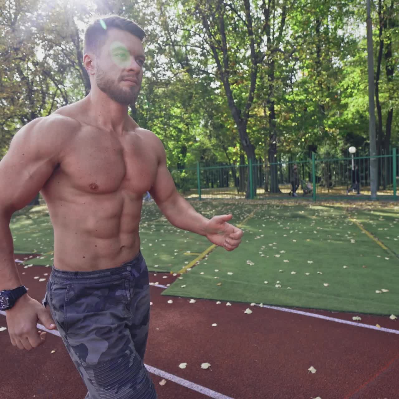 Sport man running on racetrack