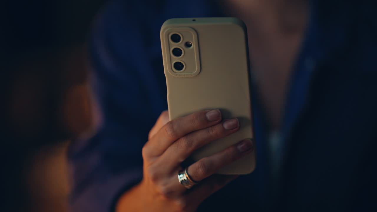 Lady hand holding phone at night home closeup. Unrecognizable businesswoman