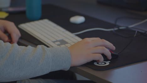 dolly of male hand using mouse on a desk