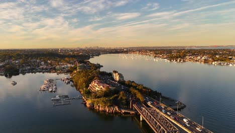 establishing drone of blakehurst suburb highway bridge with calm waters and golden sunset light, sydney nsw australia