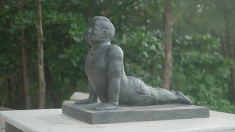 small statue in yoga position - slow panning shot