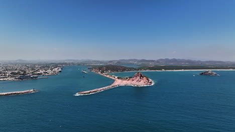 aerial view of a coastal city with a rocky island
