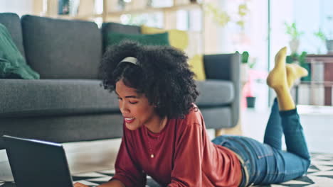 music, wink and black woman with a laptop