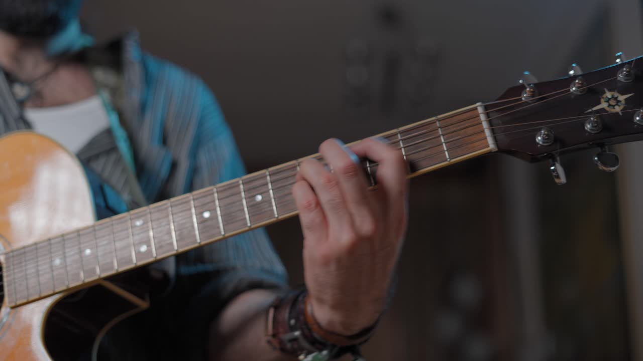 Person Playing Acoustic Guitar Closeup