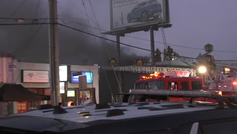 smoky building as firefighters make access