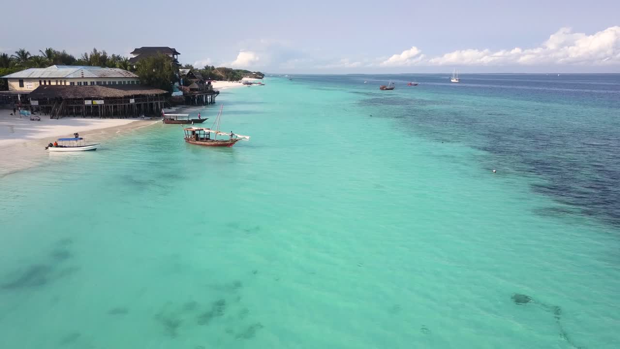 Aerial flying backwards over beautiful, calm waters off coast of Zanzibar