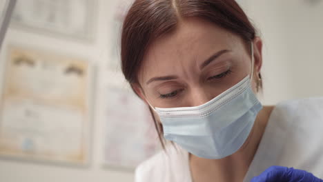 female medical professional wearing a mask and gloves