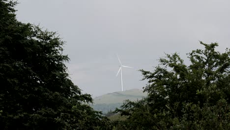 slow motion of spinning wind generators in the foggy weather.