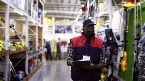 focused man working in repair supplies shot, wearing mask