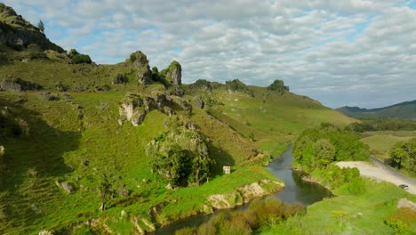 Reveal-shot-of-Castle-Craig-Rock-geological-feature-next-to-Marokopa-river