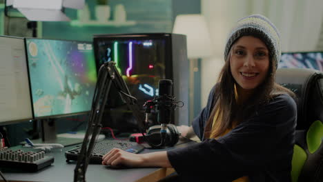 Portrait-of-woman-streamer-looking-at-camera-after-playing-space-shooter