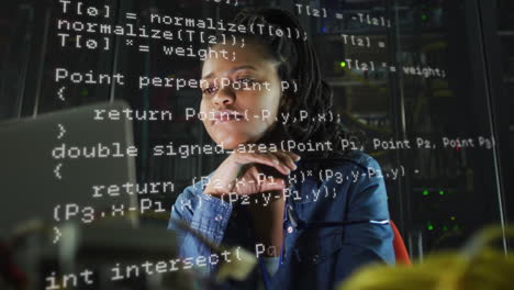 animation of data processing over biracial woman working on laptop