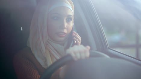 woman driving and talking on phone