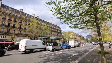 vehicles moving along a bustling parisian street