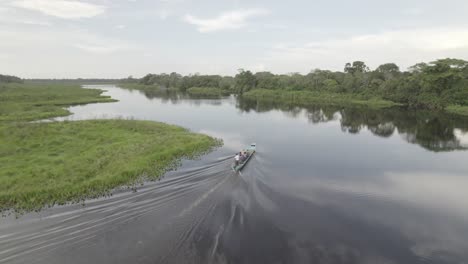 motorboat on the tranquil waters of laguna negra in colombia - aerial drone shot