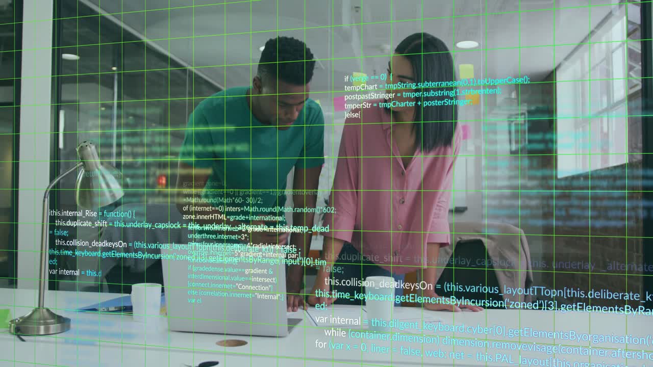 Software developers reviewing code on laptop with documents, grid overlay appearing, code cascading