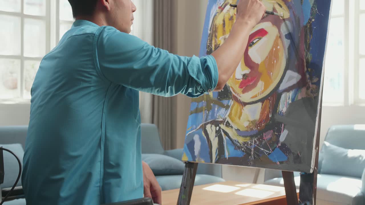 Asian Artist Man In Wheelchair Holding Paintbrush Mixed Colour And Painting A Girl On The Canvas