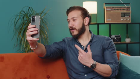 lebanese man blogger taking selfie on smartphone recording vlog stories for social media subscribers
