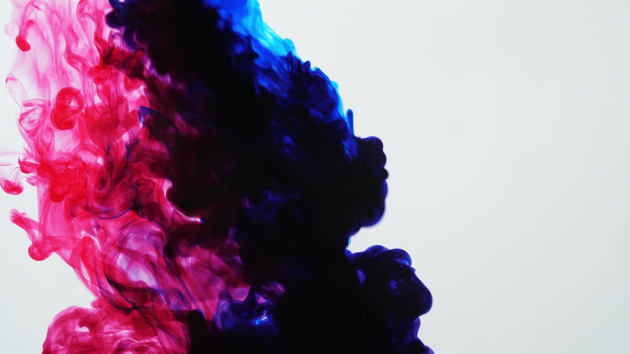 Blue And Red Ink Mixing In Water On A White Background