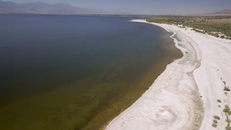 drone flying over coastline - salton sea, california desert