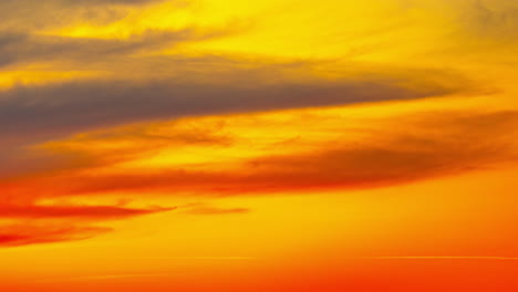 vibrant fiery sunset or sunrise sky with clouds, time lapse