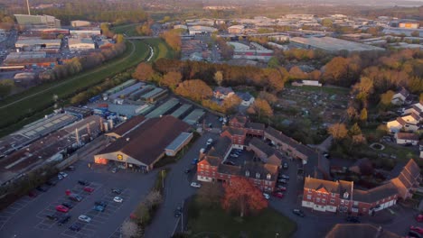 Flyover-tilt-up-during-golden-hour-in-Alphington,-Exeter,-UK