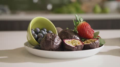 fresh fruit prepared on bowl on kitchen counter