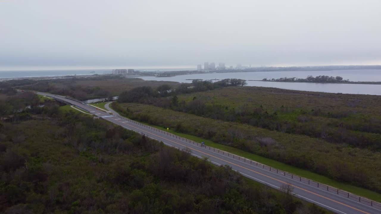 Aerial View of Coastal Road with People Walking and Cycling