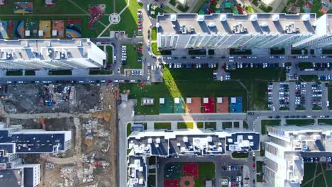 aerial view of modern residential complex with construction site and playground