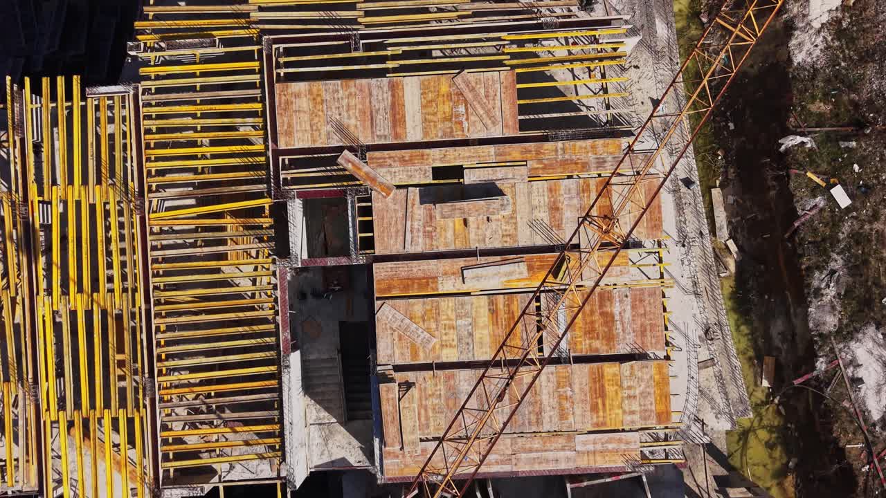 Aerial View of Construction Site with Crane and Concrete Foundation