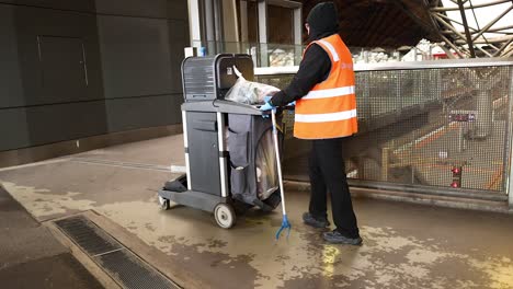 worker collects trash at melbourne station