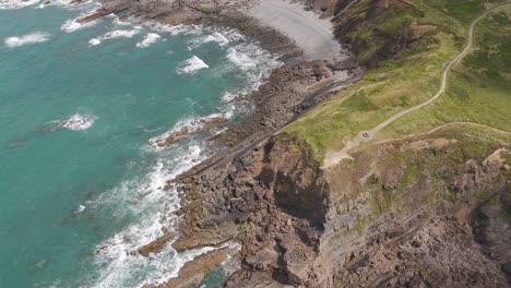 Aerial View of Rugged Coastline with Cliffs and Rocky Beach