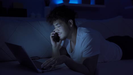 young man making phone call at night, feeling happy.