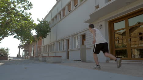 teenager performing parkour in the street