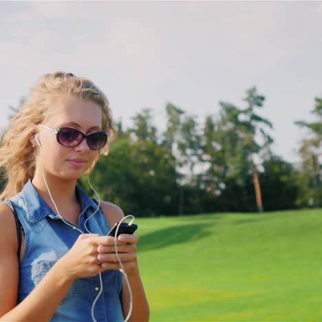 a young attractive woman walks in a well-groomed park on a summer day 3