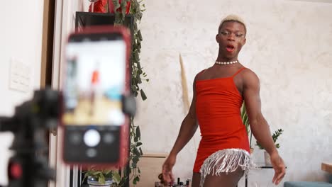 drag queen performing and vlogging in red dress