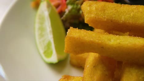 Plato-De-órbita-Lenta-Y-Concentración-Con-Polenta-Frita,-Ensalada-Y-Lima