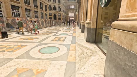 people walking inside historic shopping gallery