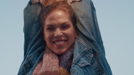 portrait beautiful young caucasian woman smiling happy with arms raised enjoying independent lifestyle on rooftop having fun weekend in city