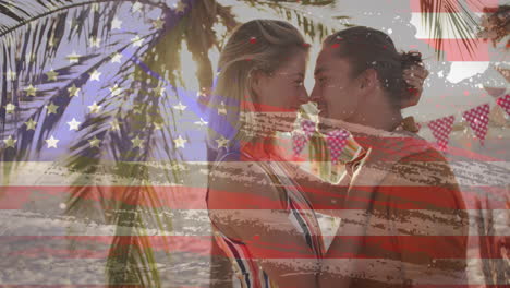 american flag animation over couple embracing under palm trees on beach