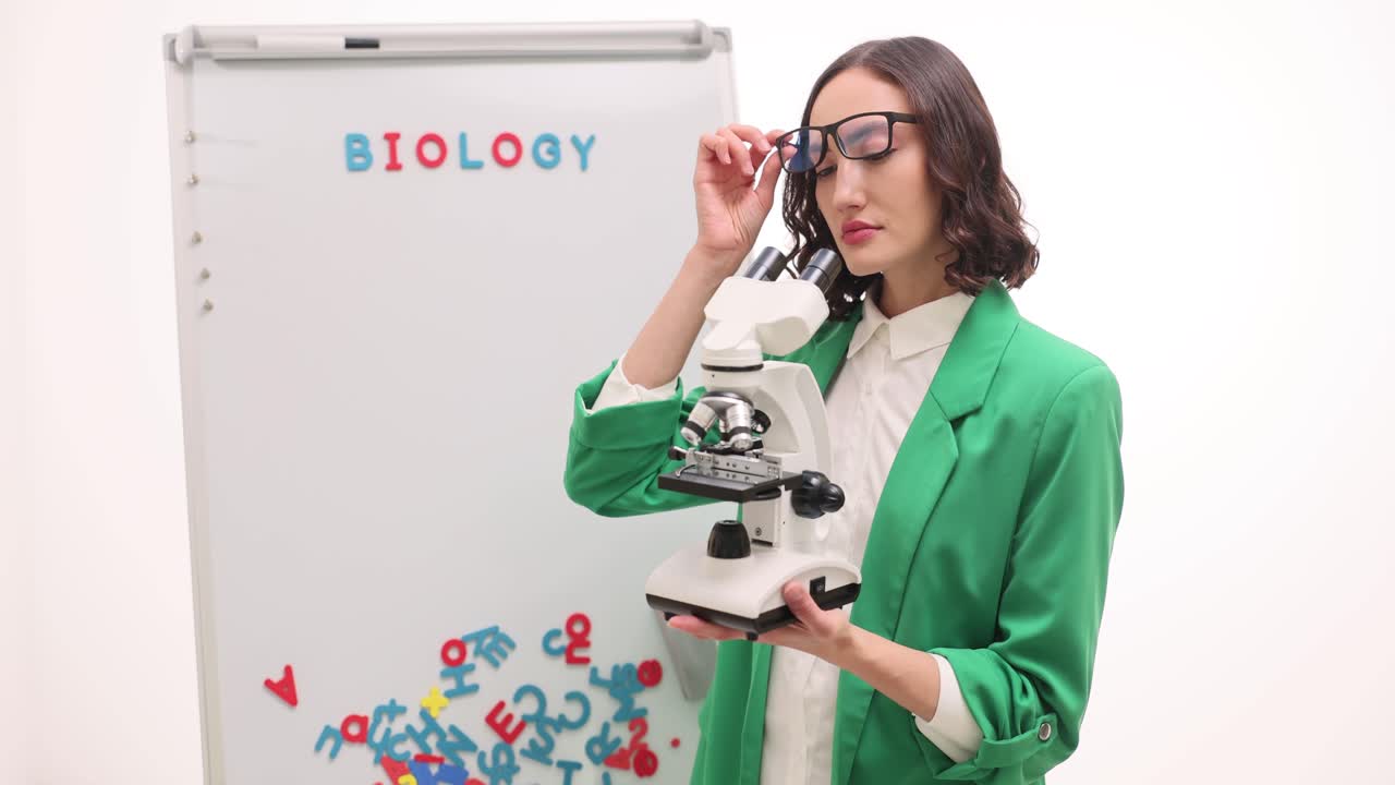 Woman with Microscope and Biology Whiteboard