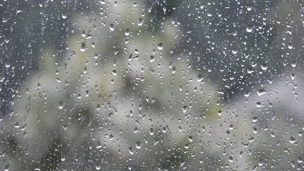 Rainy weather outside the window. Close up of a window with rain drops falling down