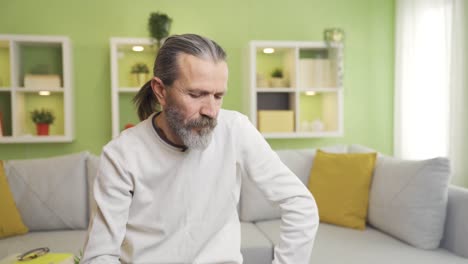 sad and depressed old man thoughtful at home alone.